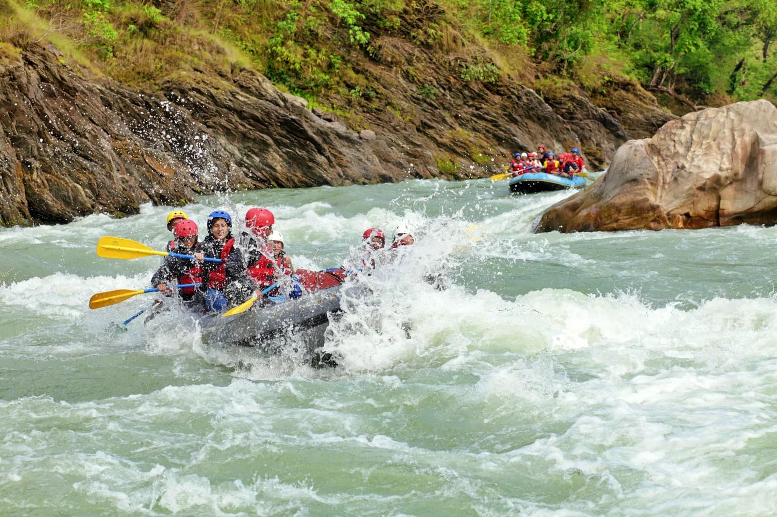 A person gliding on a zipline high above the river in Koprulu Canyon